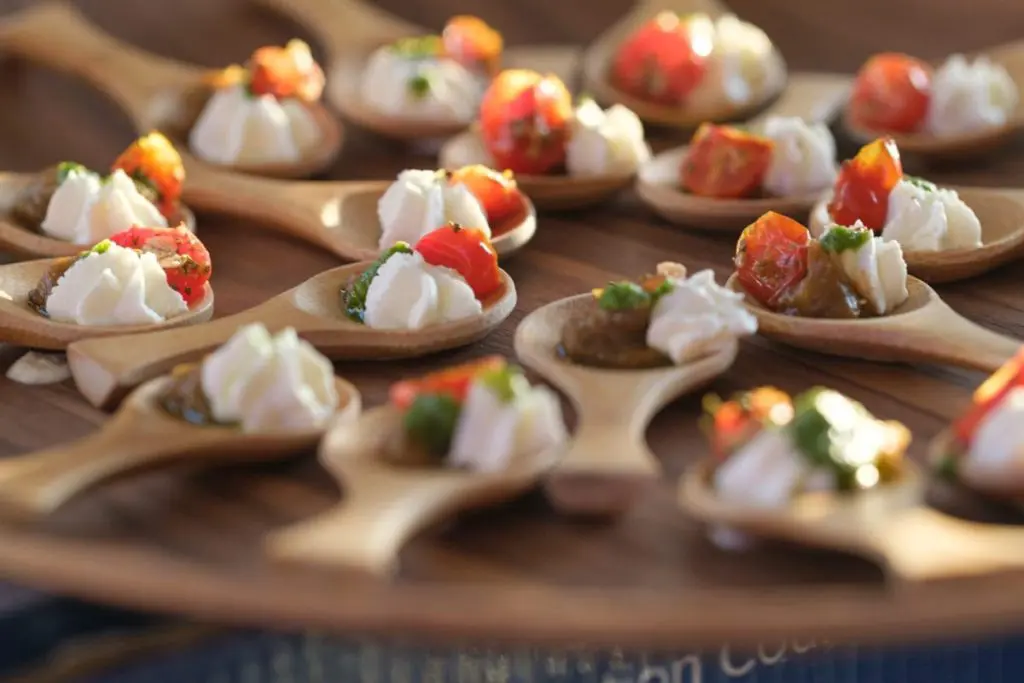 Passed appetizers on wooden spoons at a corporate event reception